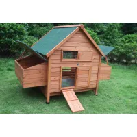 Wooden chicken coop with green pitched roofs, mesh window, doors, side runs and a front ramp on grass