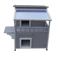 Front view of a grey wooden two-level animal shelter with a roof, balcony railing and lower doorway