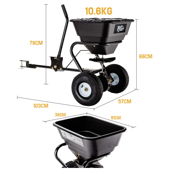 Black tow-behind spreader with measurement labels and an inset view of its open hopper