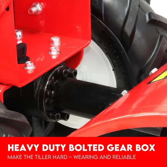 Close-up of the tiller's black bolted gear housing beside a white wheel and red frame