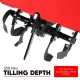 Close-up of multiple curved black tilling blades mounted beneath a red metal cover